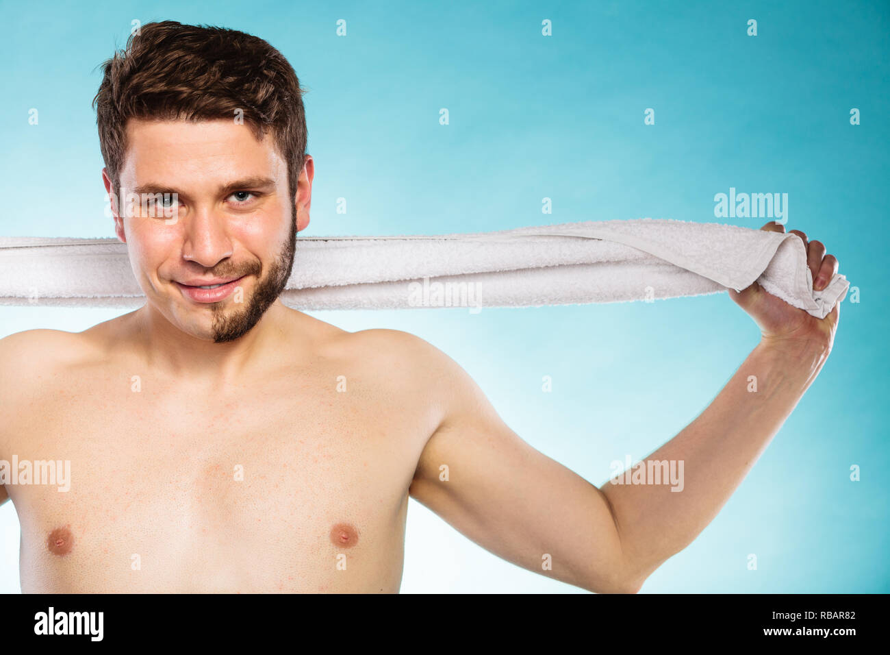 Portrait of happy man with half shaved face beard hair. Smiling