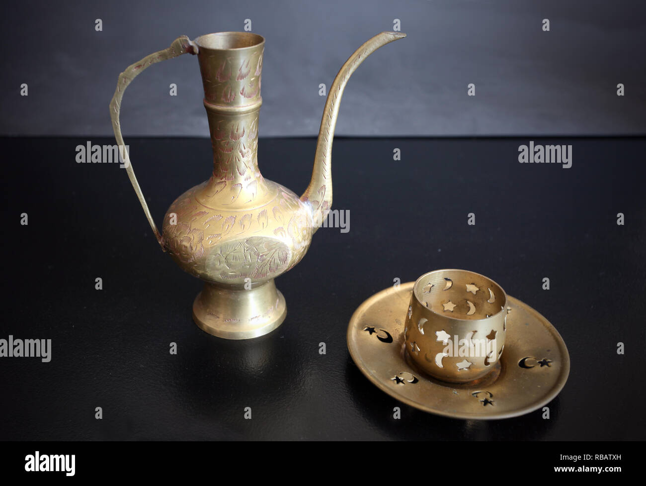 Copper articles, handmade. Ancient metal tank for liquids and a candlestick. Still life. Stock Photo