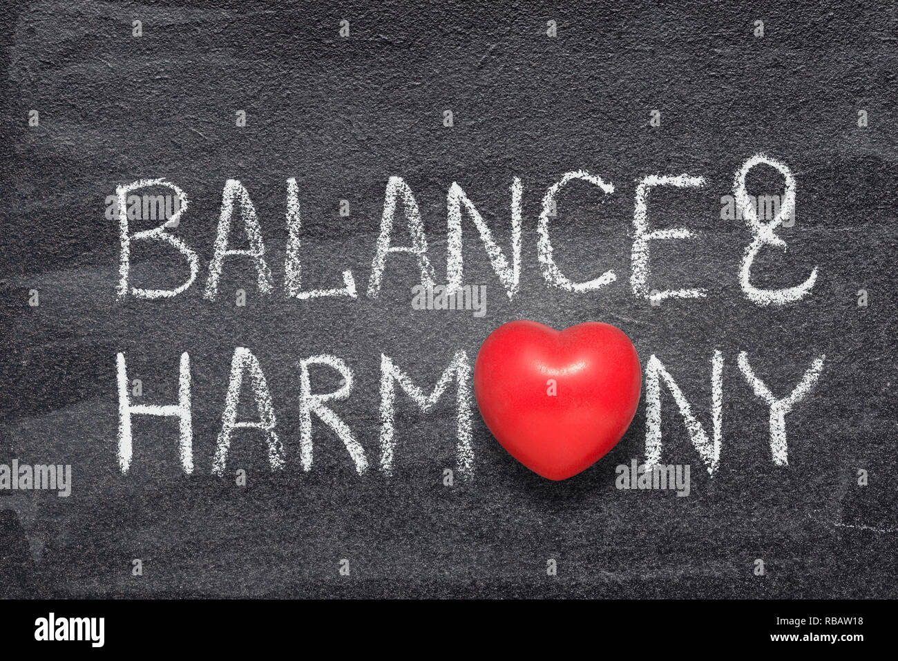 balance and harmony phrase handwritten on chalkboard with red heart symbol instead of O Stock Photo