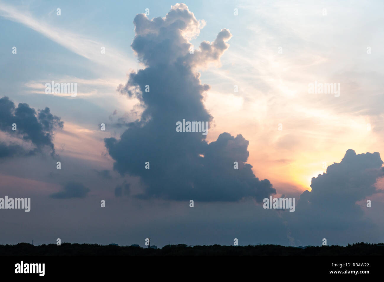 clouds forming a shape of a waving animal Stock Photo