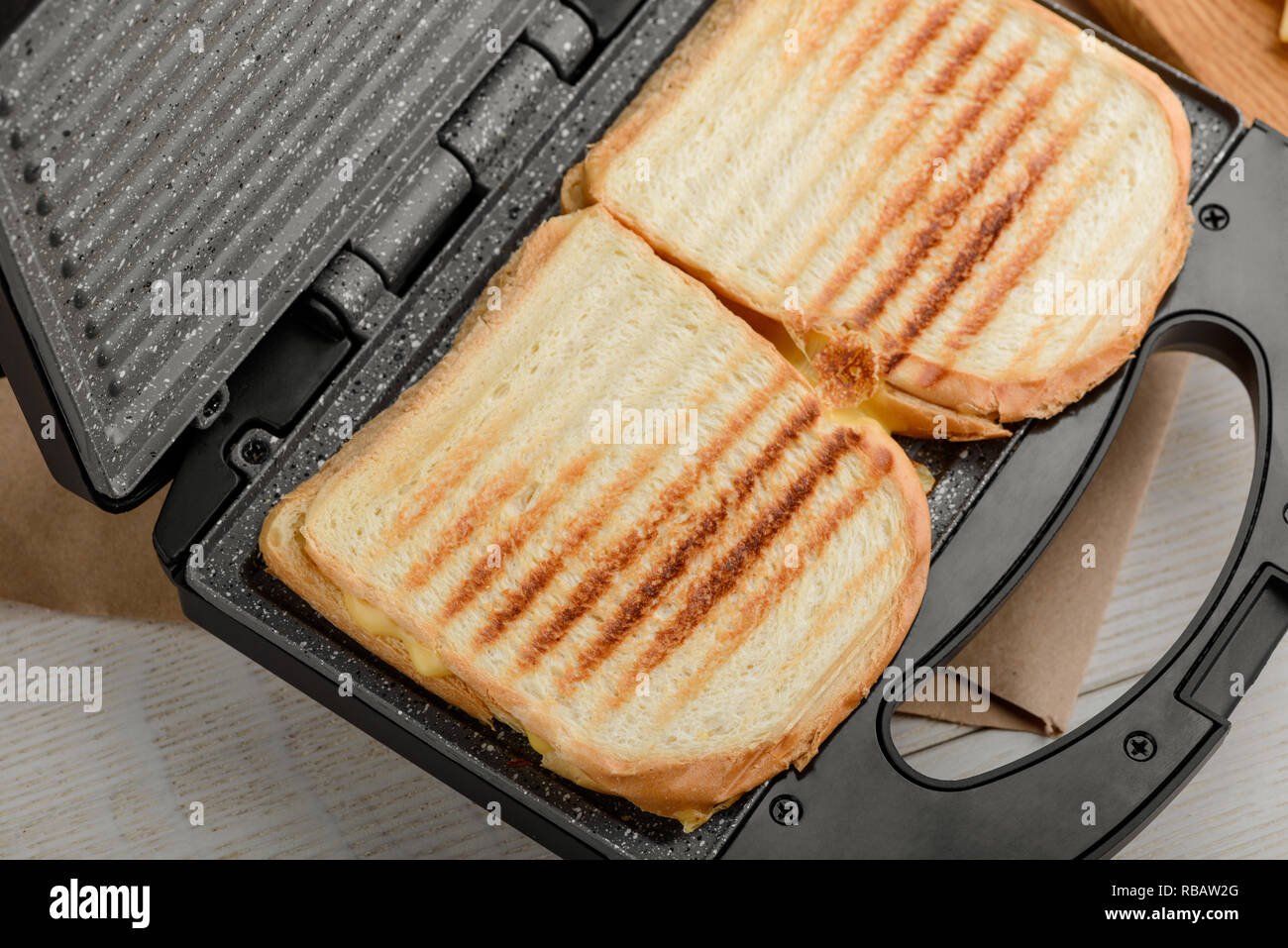 Grilled sandwiches in panini press Stock Photo Alamy
