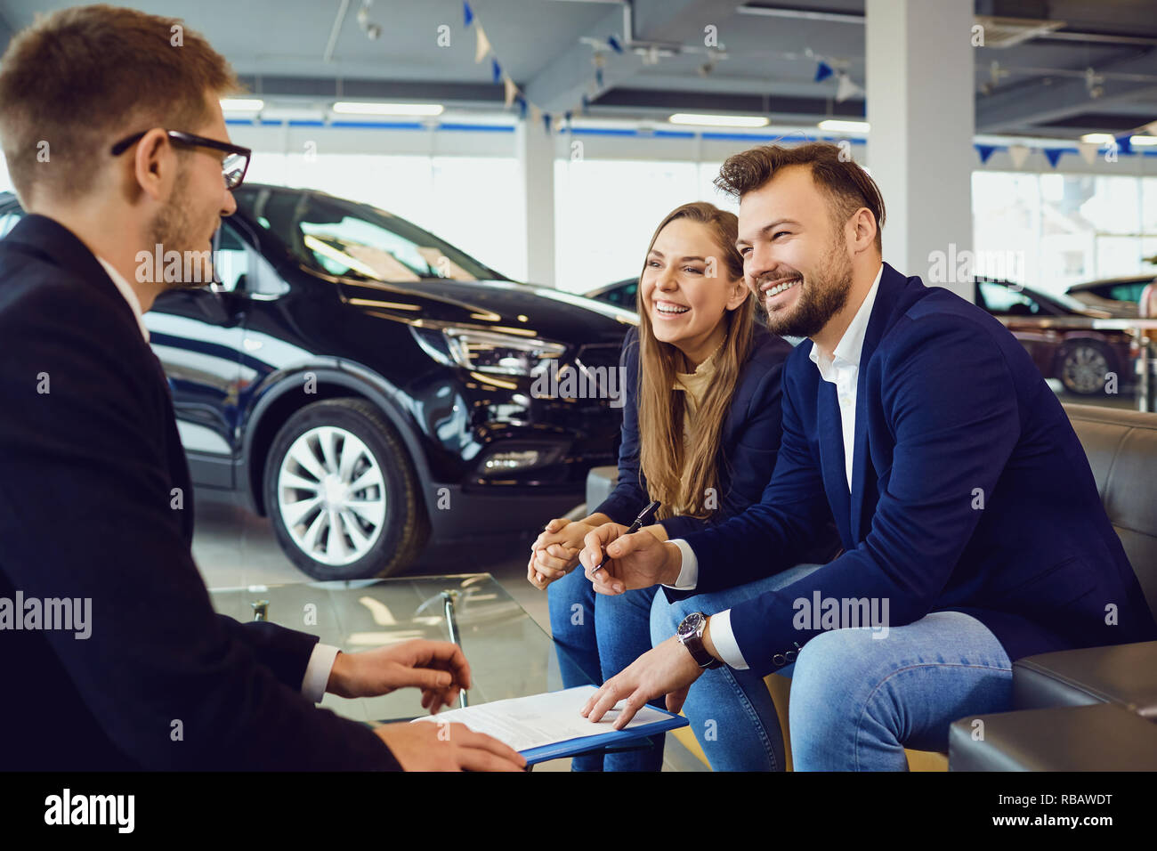 Couple buys a car in a car dealership Stock Photo Alamy