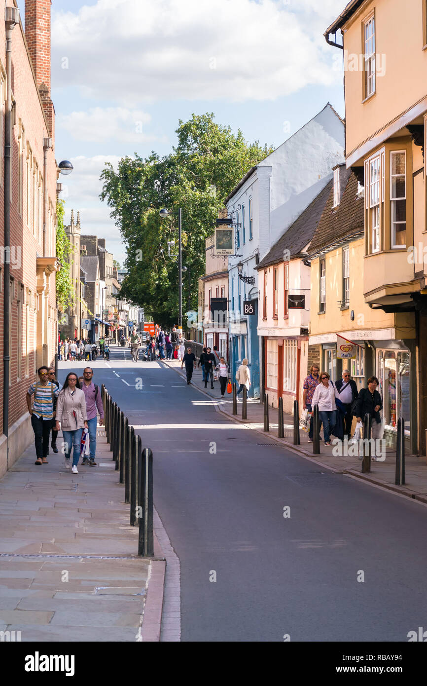 People walking along Bridge Street past shops on a sunny Summer afternoon, Cambridge, UK Stock Photo