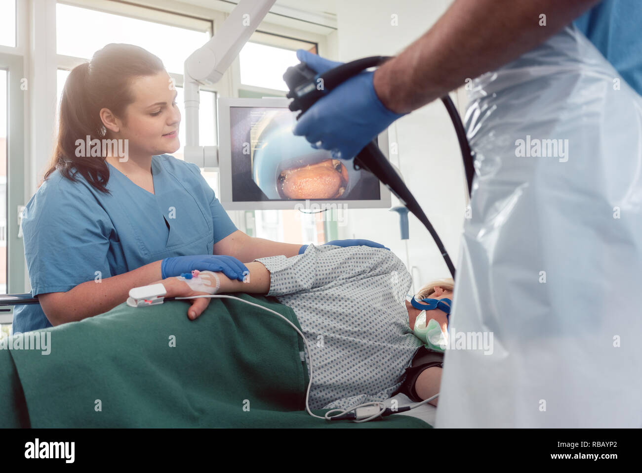 Doctor during endoscopy checking picture of mouth on screen Stock Photo