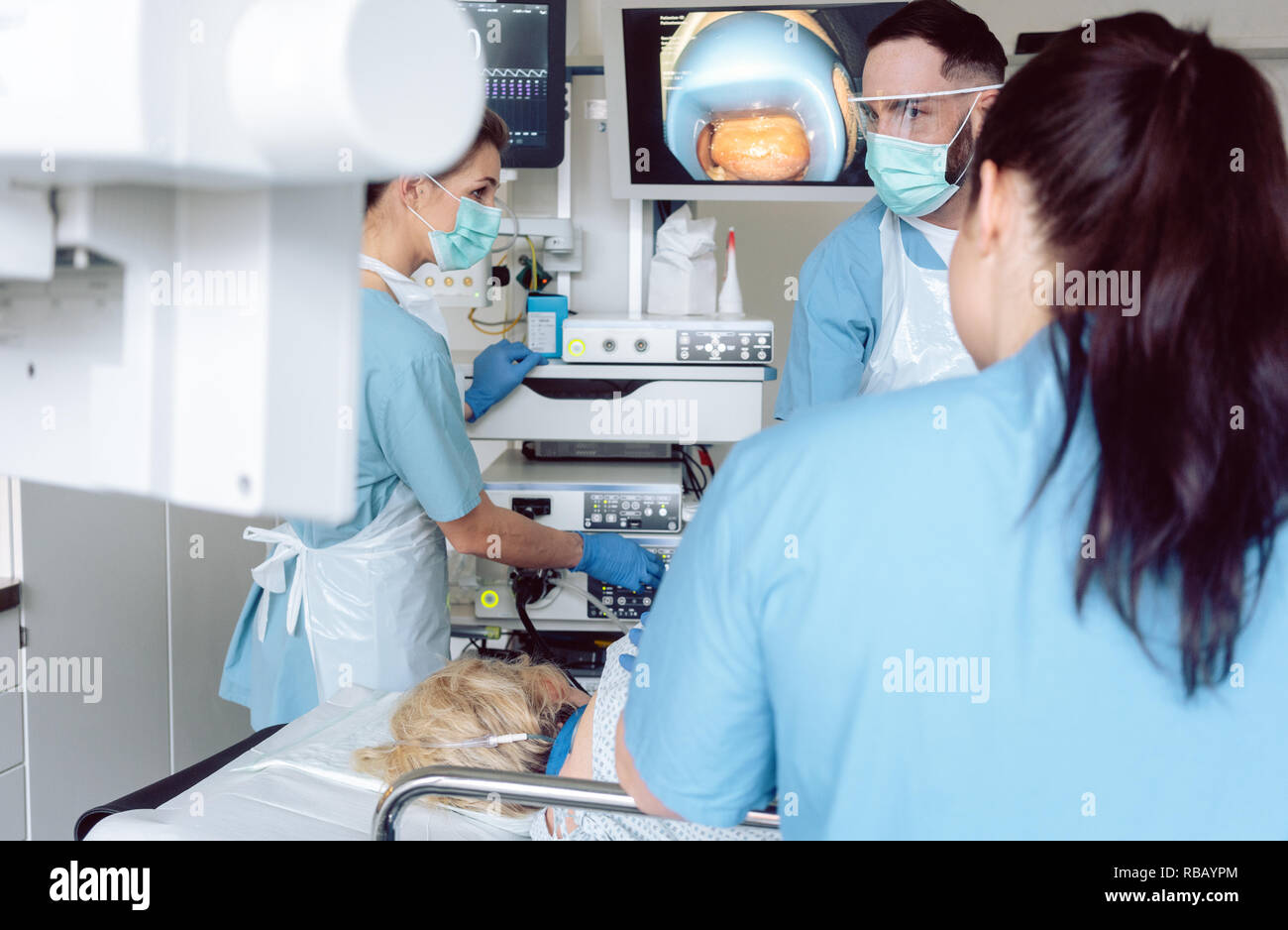 Team of doctors in hospital at endoscopy examining pictures Stock Photo ...