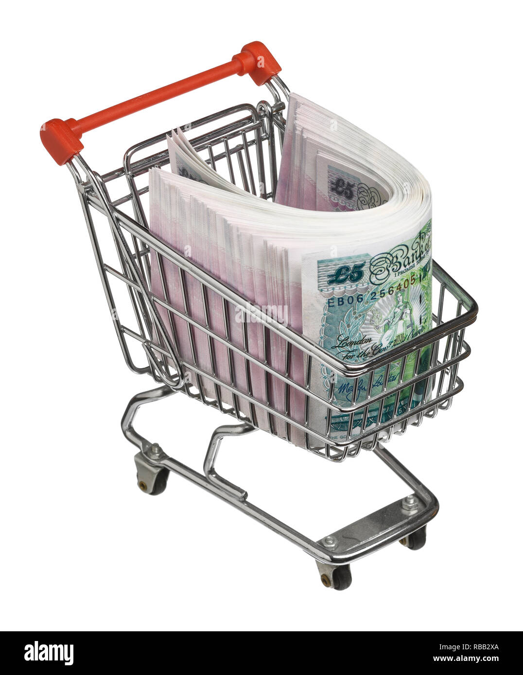 Mini shopping trolley filled with UK pound sterling five pound notes Stock Photo