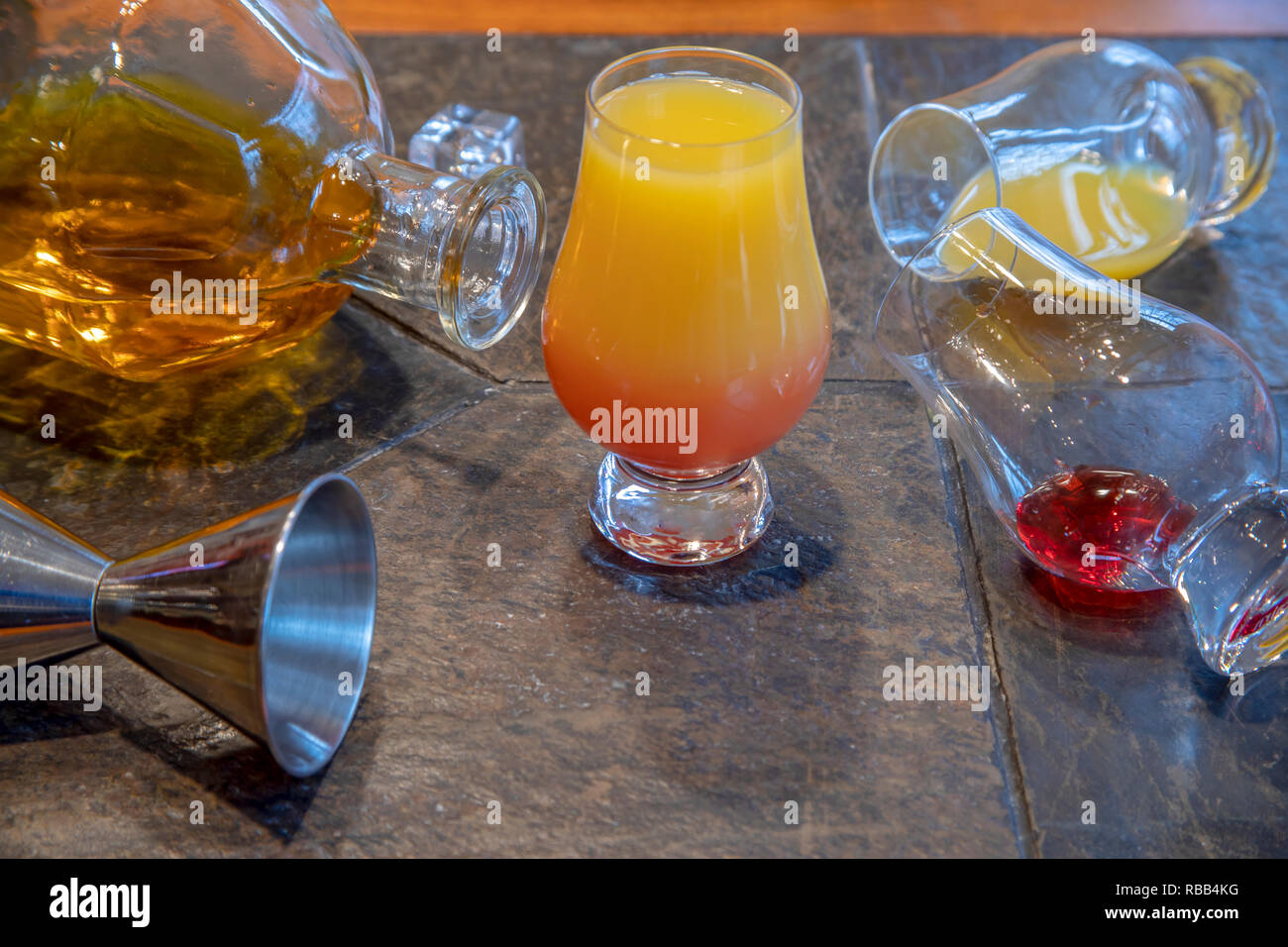 Ingredients For Tequila Sunrise Including Tequila Bottle Orange Juice Grenadine And Ice Cubes On Slate Table Stock Photo Alamy