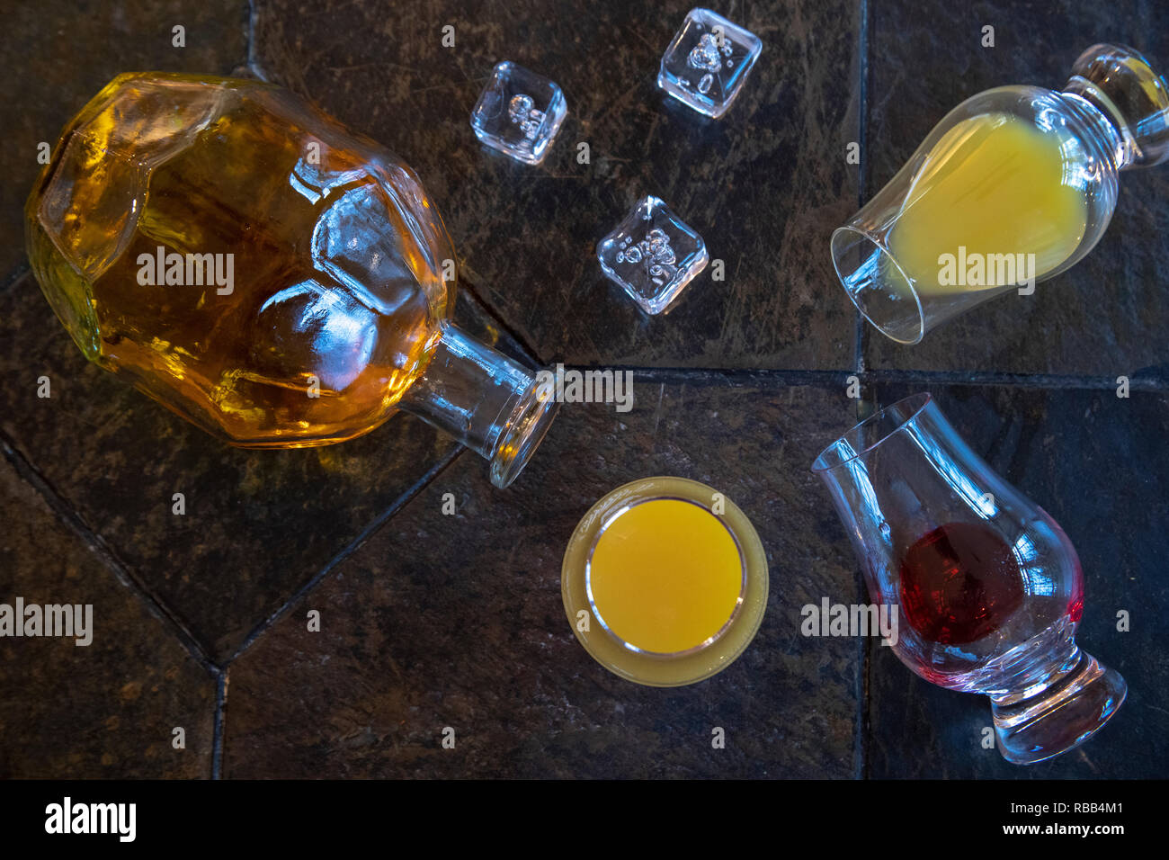 Ingredients for tequila sunrise including tequila bottle, orange juice