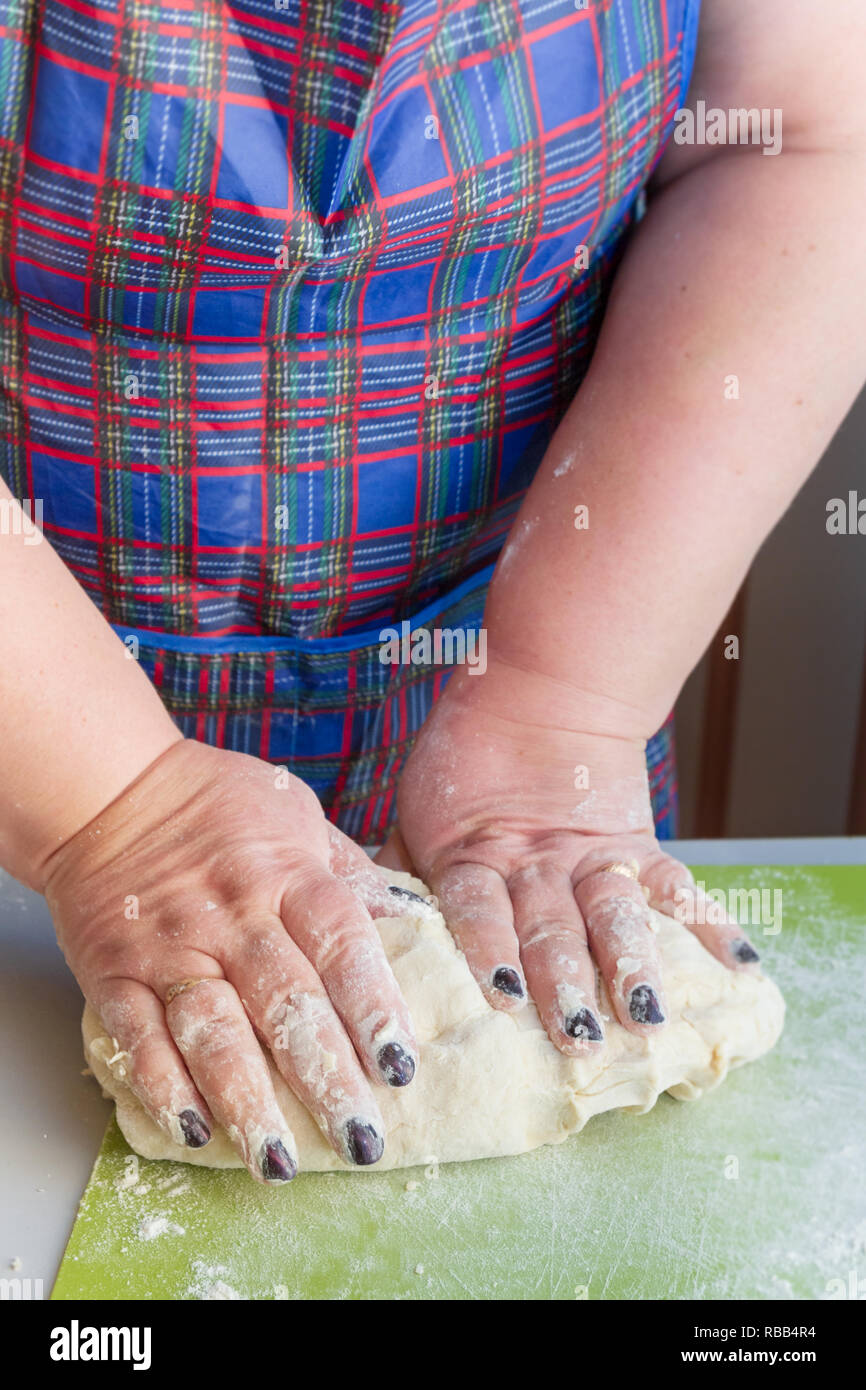 Knead the dough with your hands on the table Stock Photo - Alamy