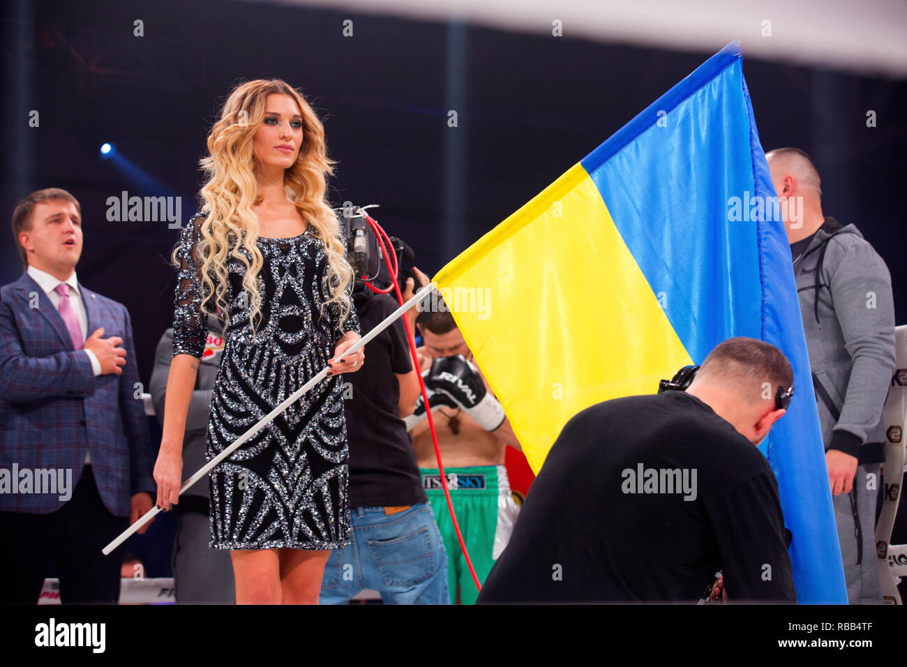 Professional Ukrainian model holds national flag before international pro boxing match Denis Berinchyk vs R.Crystobal, promoter Alexander Krassyuk (L) Stock Photo