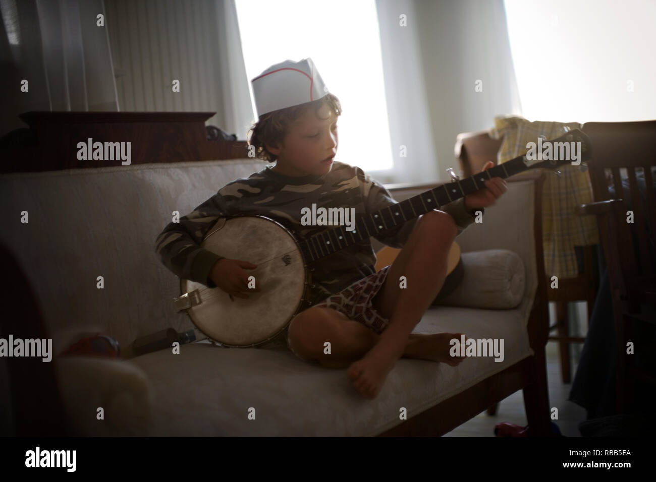Young boy playing a banjo Stock Photo Alamy