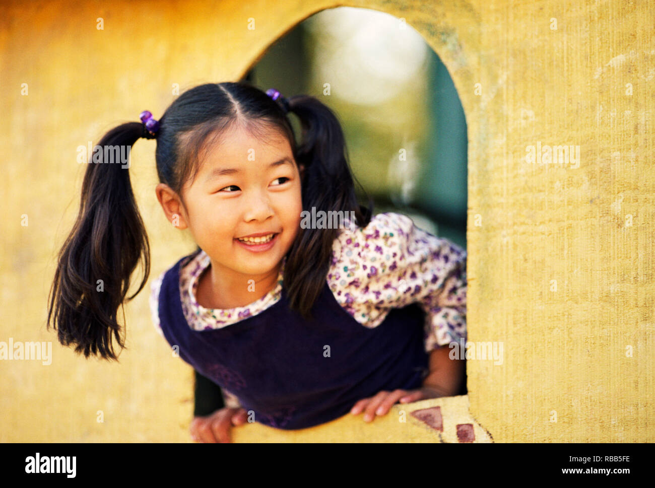 Smiling young boy playing in a playground Stock Photo - Alamy