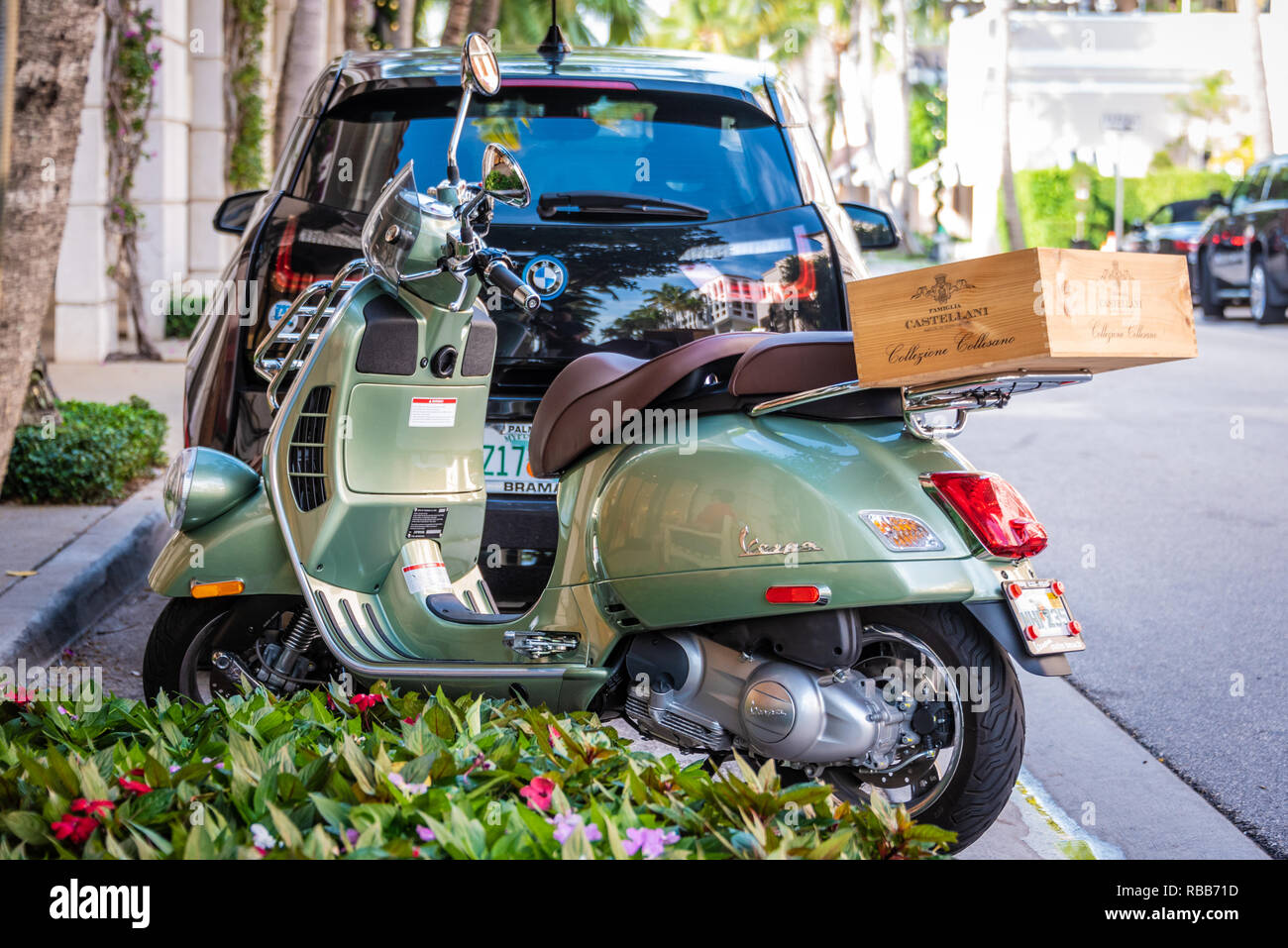 Vespa motor scooter with Tuscan wine crate outside of Saks Fifth Avenue at the Esplanade on Worth Avenue in Palm Beach, Florida. (USA) Stock Photo