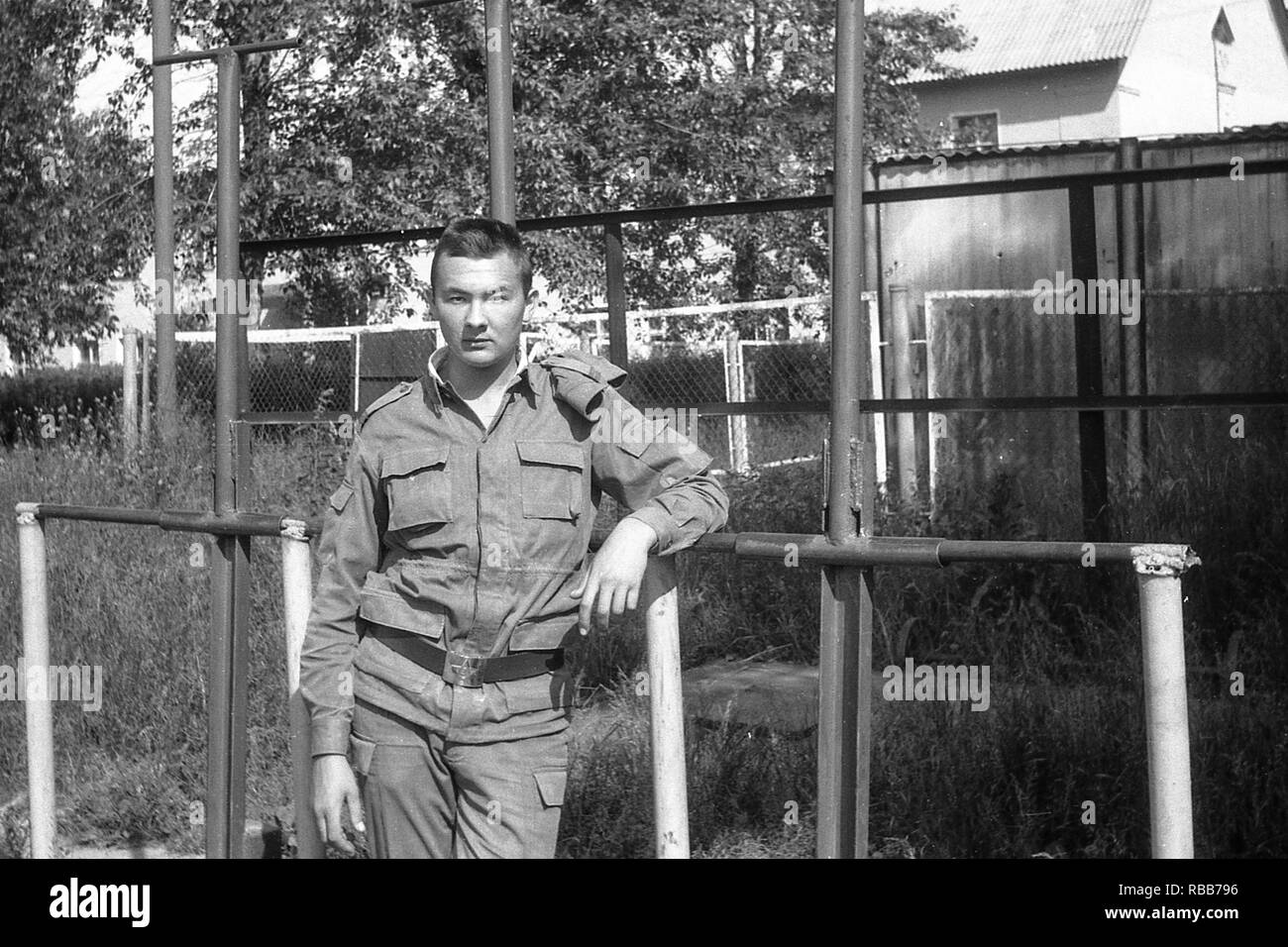 MOSCOW REGION, RUSSIA - CIRCA 1992: Soldier of the Russian army on the sports field. Film scan. Large grain. Stock Photo