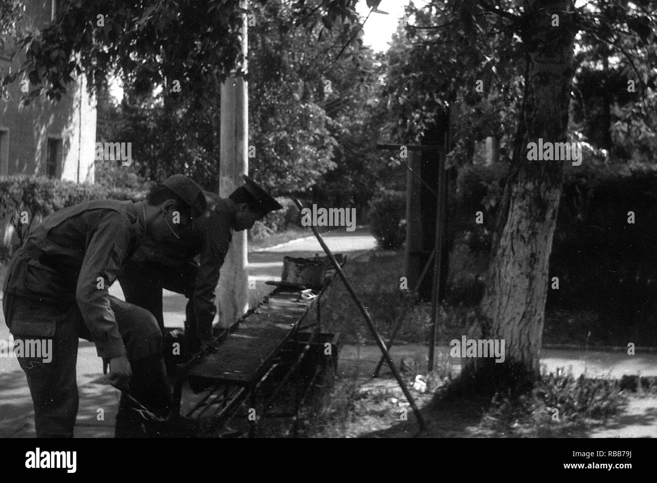 MOSCOW REGION, RUSSIA - CIRCA 1992: Soldiers of the Russian army are cleaning boots with shoe cream. Film scan. Large grain. Stock Photo
