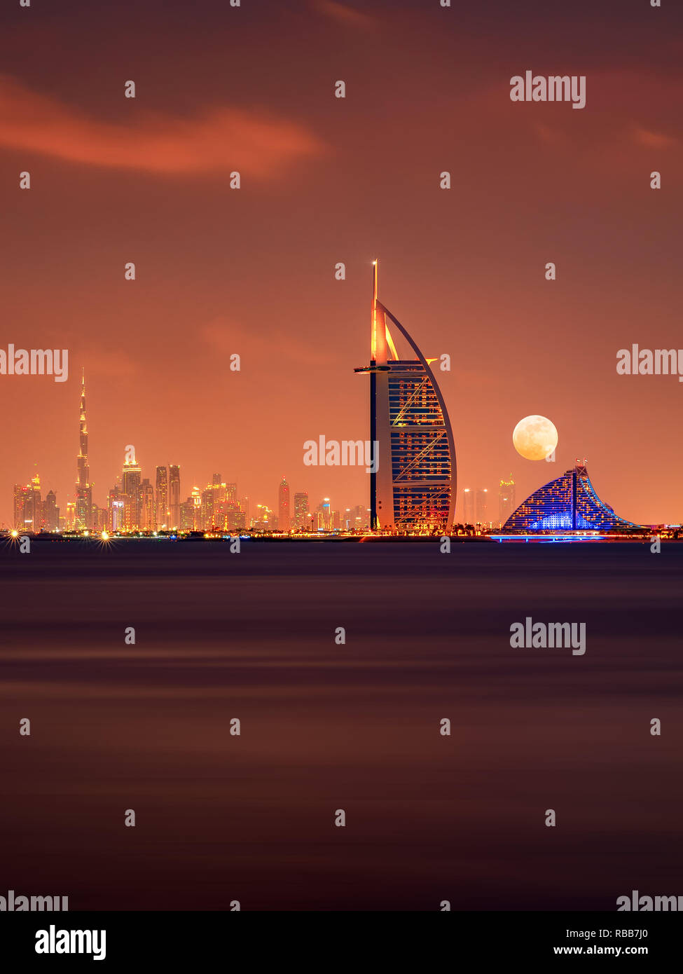 Burj Al Arab and Burj Khalifa in a beautiful panoramic skyline view at night in Dubai, UAE Stock Photo