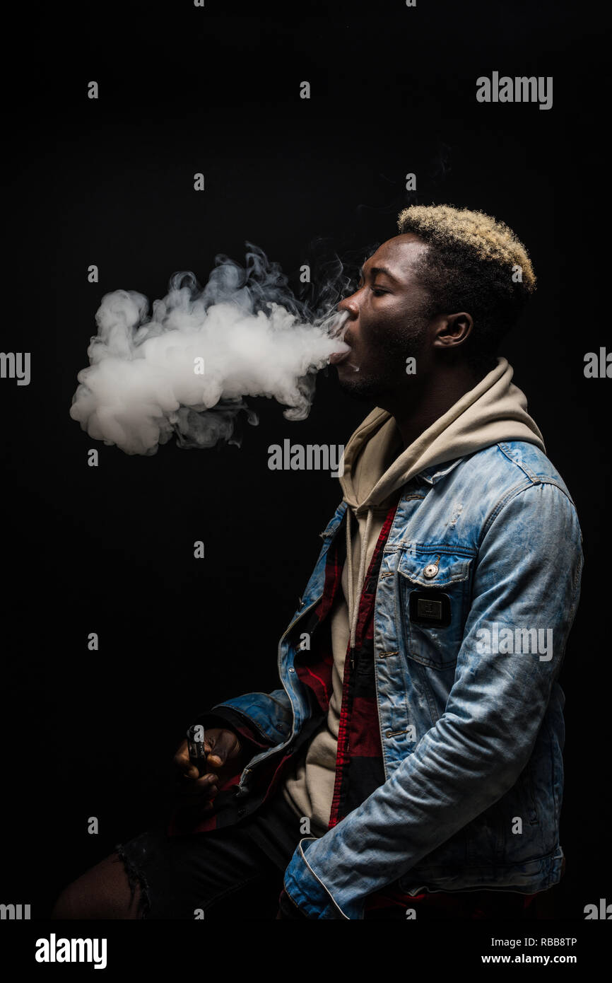 African Man smoking or vaping e cig or electronic cigarette