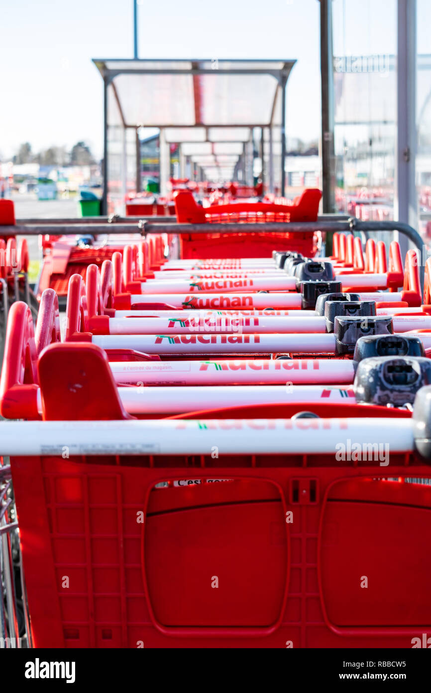 Roncq,FRANCE-February 25,2018: Close-up shopping trolleys Auchan hypermarket.Auchan is a French international supermarket chain. Stock Photo