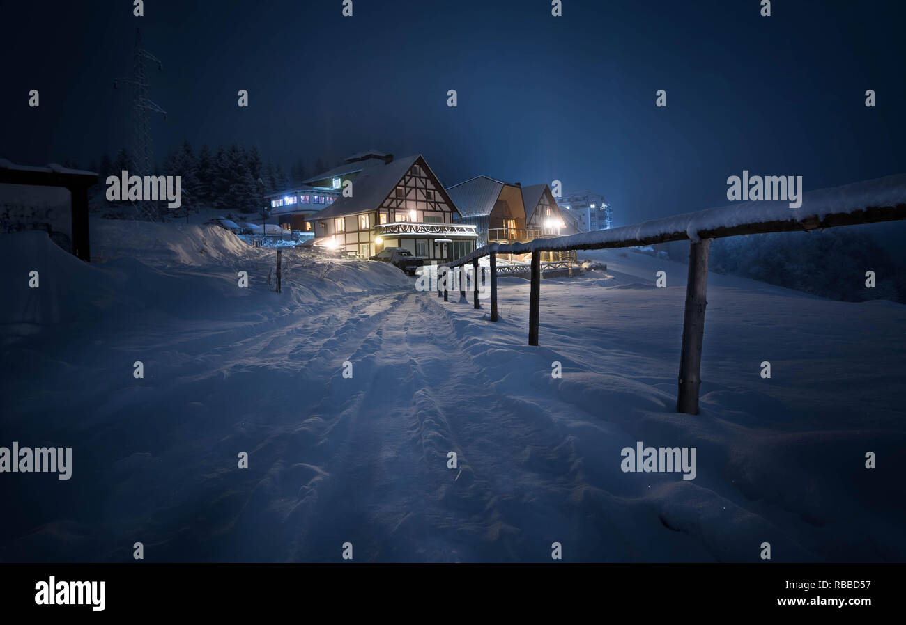 romantic house on the snow at night Stock Photo