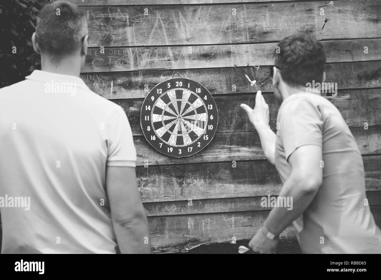 two friends playing darts Stock Photo