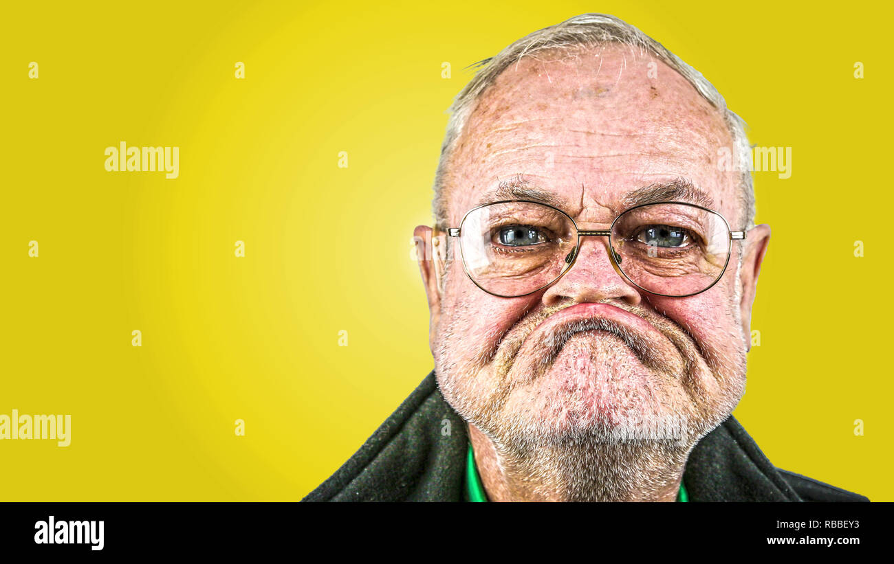 grumpy old man with glasses Stock Photo