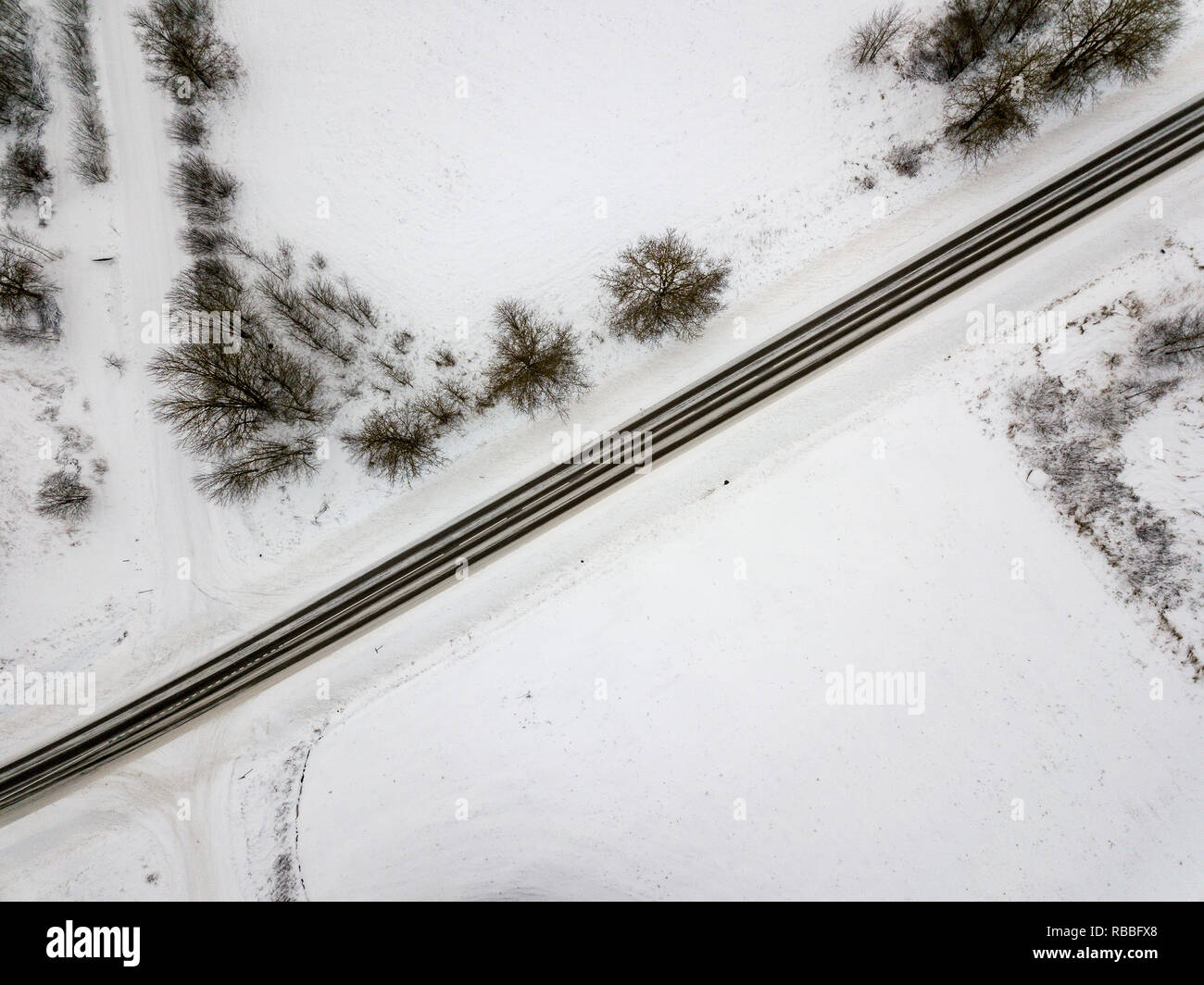 beautiful straight country asphalt road with white lines in winter from