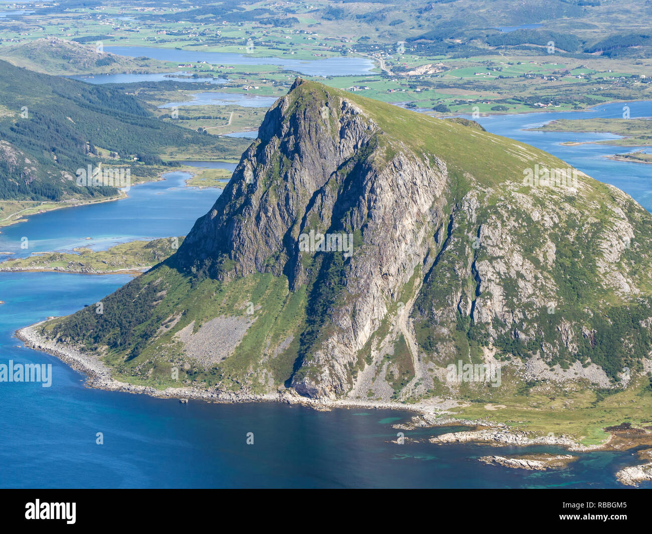 View from top of mountain Stornappstind to island Offersöya, large cliff in the  sea,  Lofoten, Norway Stock Photo