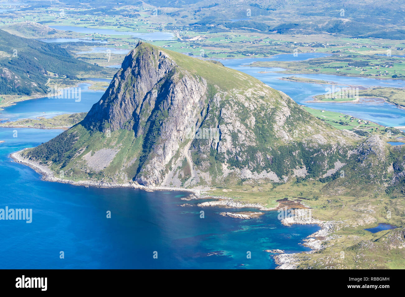 View from top of mountain Stornappstind to island Offersöya, large cliff in the  sea,  Lofoten, Norway Stock Photo