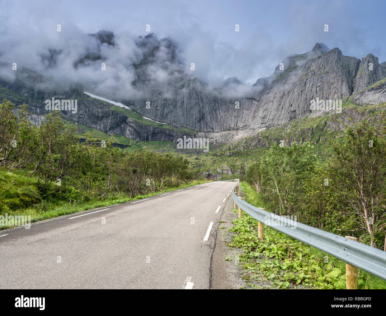 Steep granite cliffs at the road to Nusfjord, narrow single track road, Nusfjord, Flakstadøy, Lofoten, Norway Stock Photo