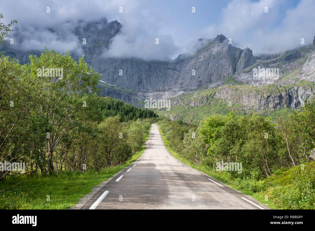 Steep granite cliffs at the road to Nusfjord, narrow single track road, Nusfjord, Flakstadøy, Lofoten, Norway Stock Photo