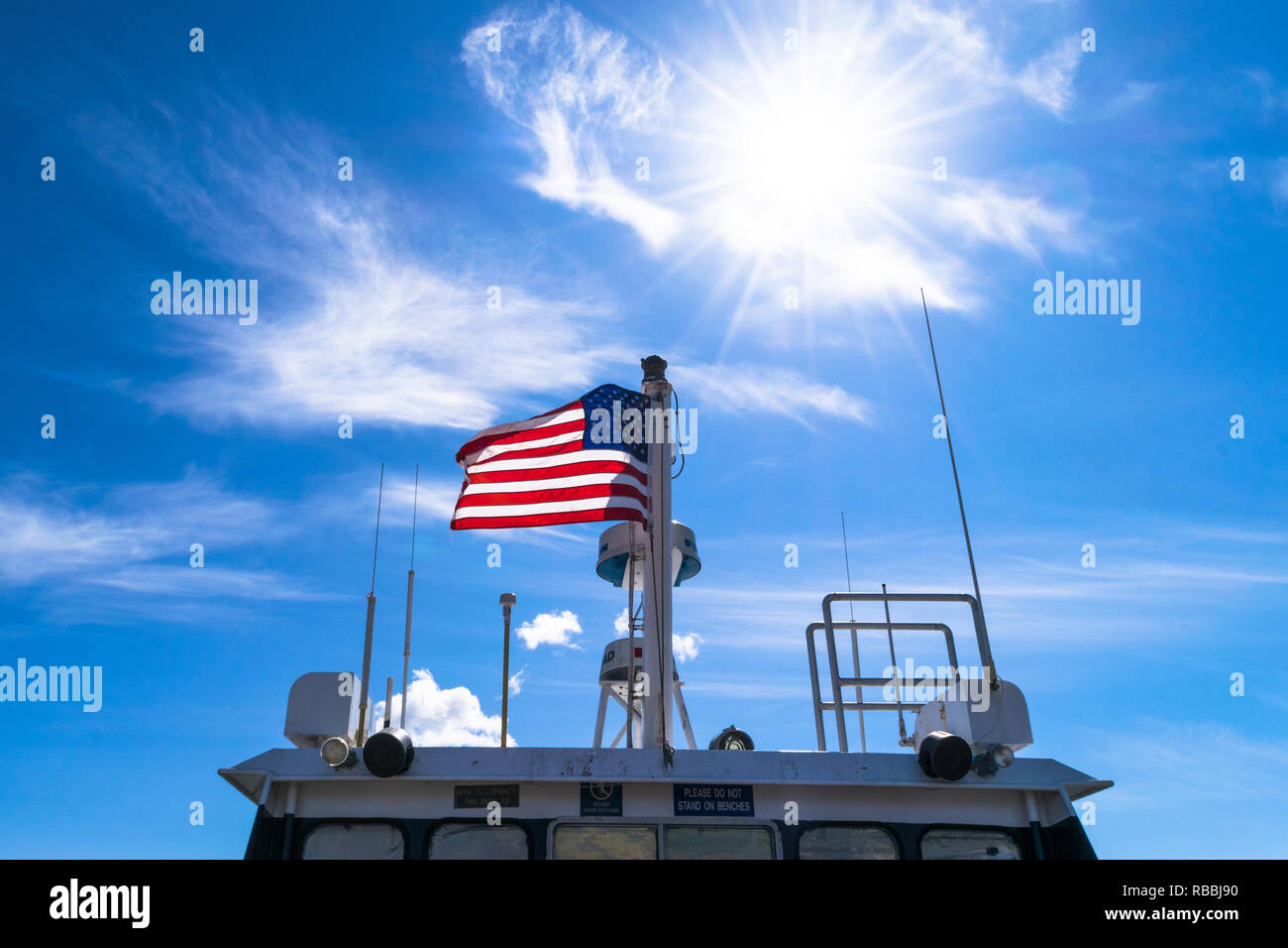 Majestic United States flag with blue sky background Stock Photo Alamy