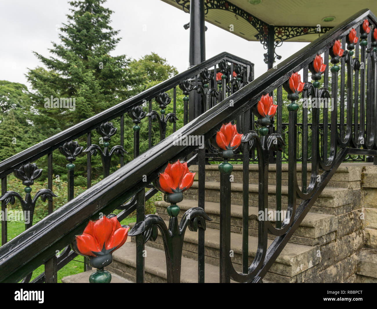 Decorative wrought iron railings with a floral motif on the bandstand in the Pavilion Gardens, Buxton, UK Stock Photo