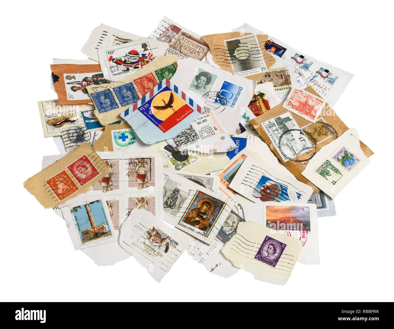 A collection of stamps from around the world torn from envelopes Stock Photo