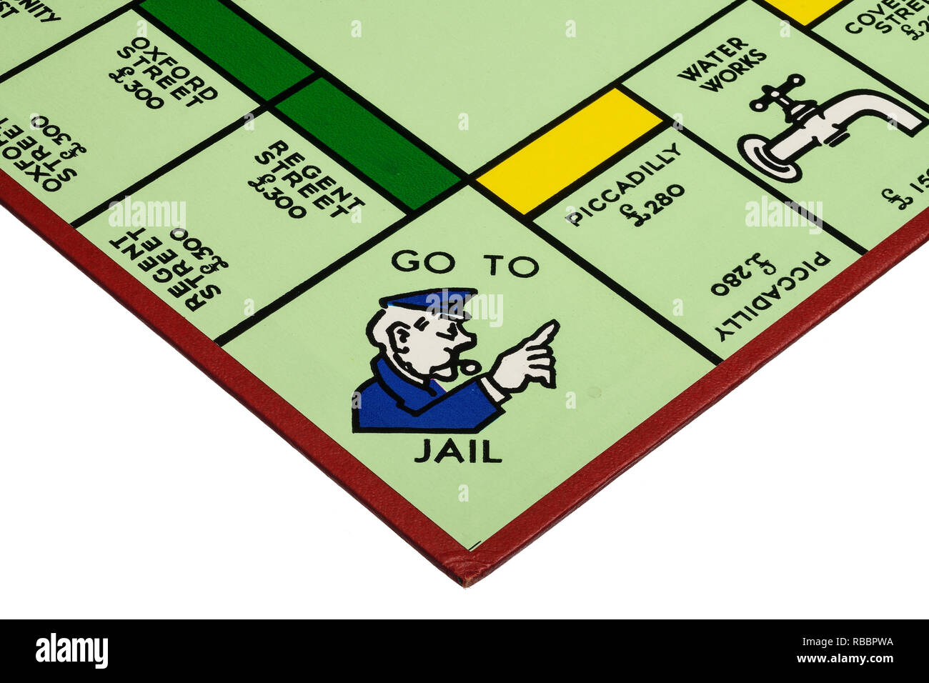 Close up detail of a corner of the playing board for the game of Monopoly showing Go To Jail Stock Photo