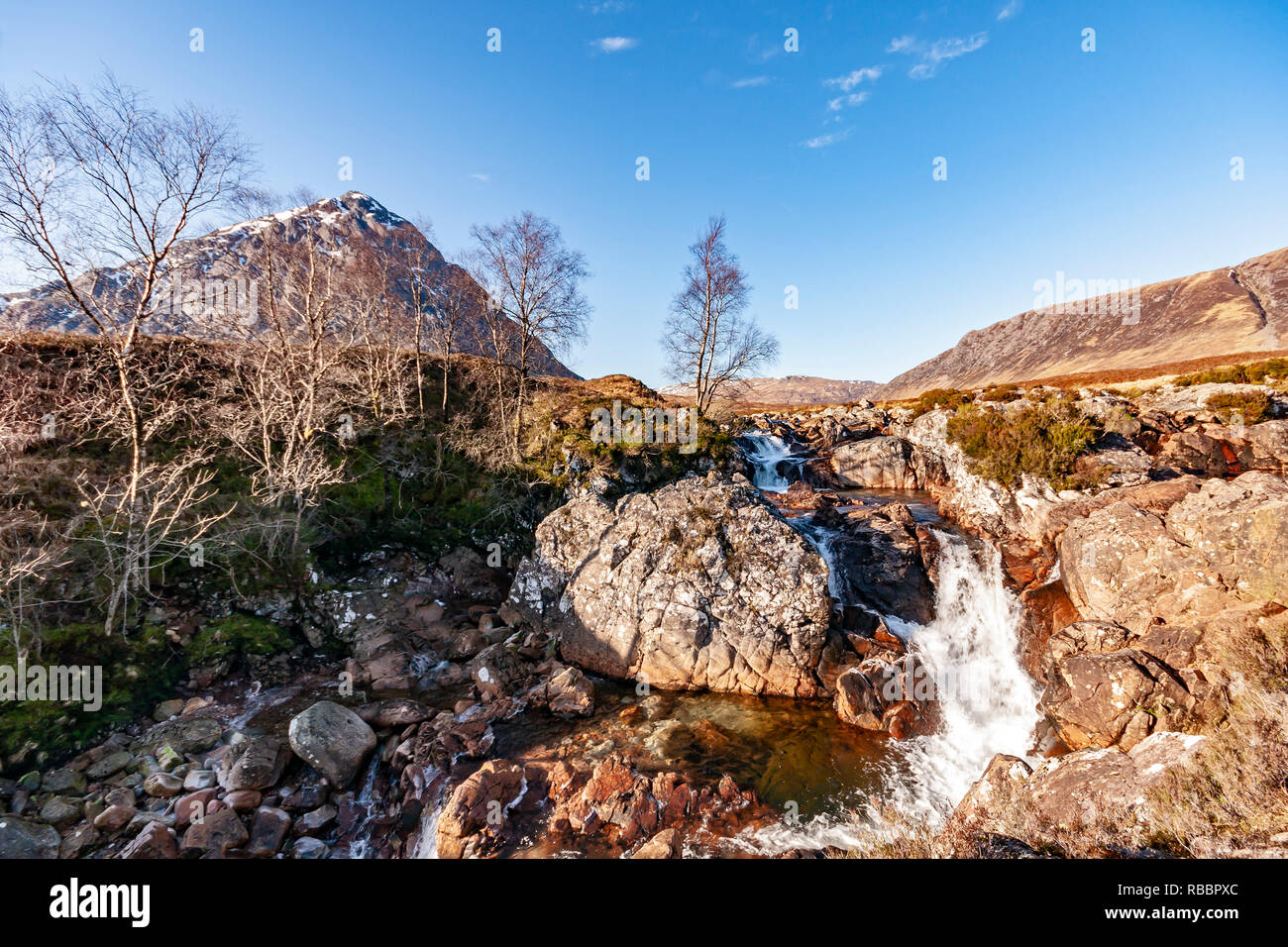 Etive Mor Waterfall at River Coupall where upper Glen Etive meets Glen Coe with famous mountain Buachallie Etive Mor - The Shepherd of Etive - behind Stock Photo
