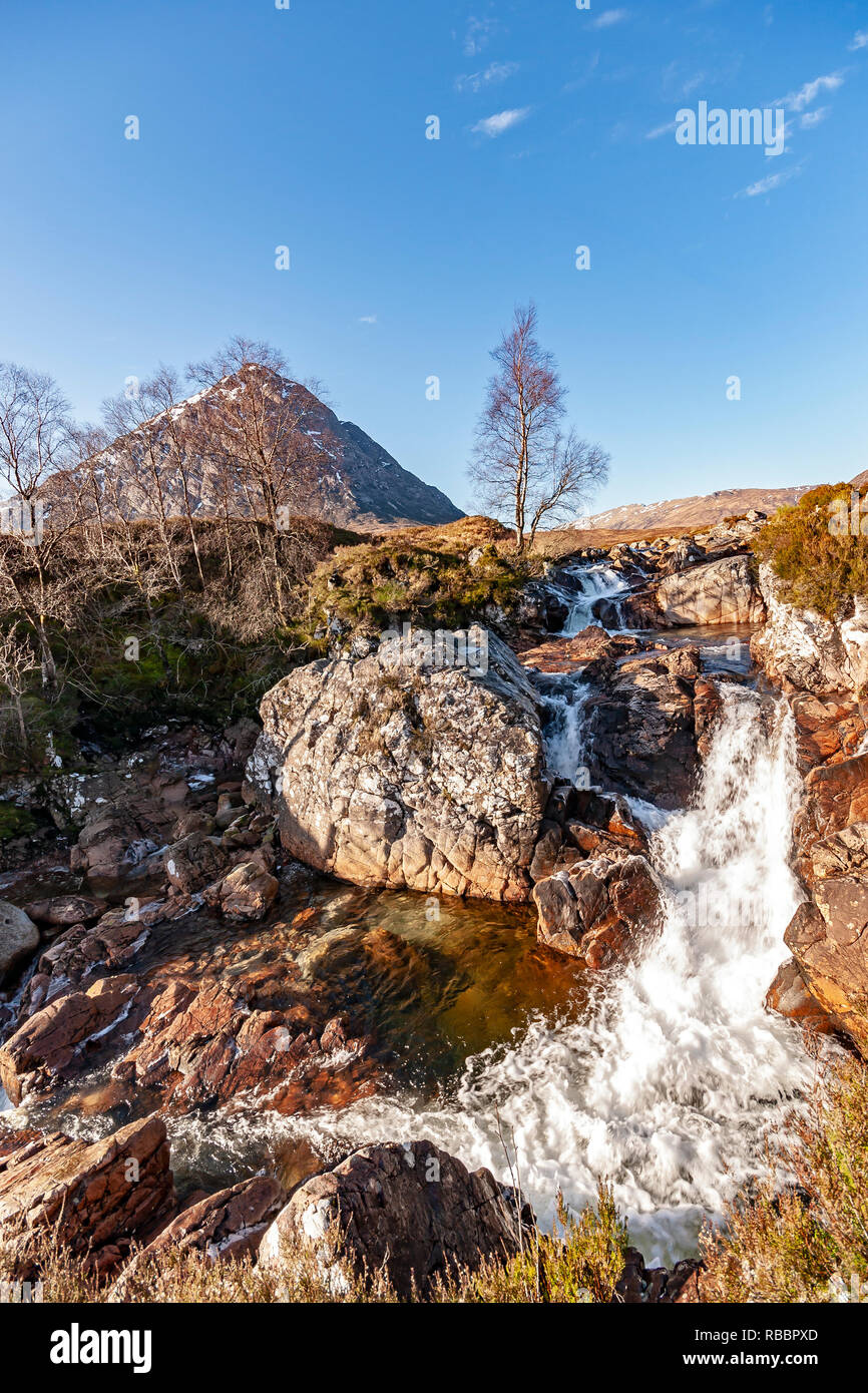 Etive Mor Waterfall at River Coupall where upper Glen Etive meets Glen Coe with famous mountain Buachallie Etive Mor - The Shepherd of Etive - behind Stock Photo
