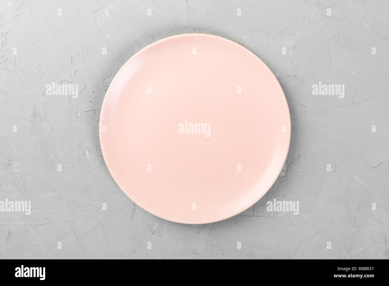 Top view of matte round empty rose dish on grey cement background space ...