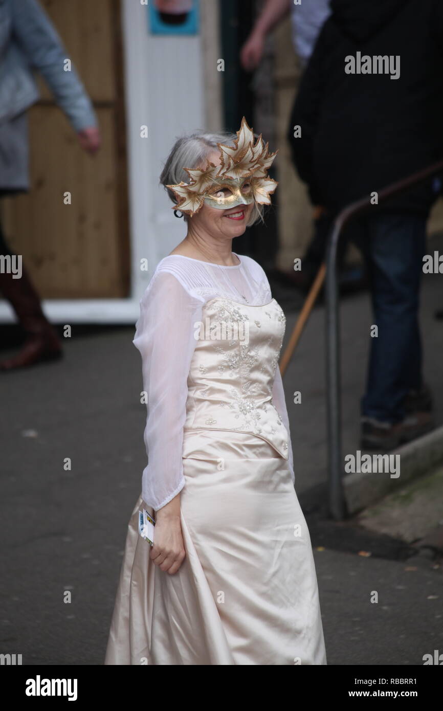 Elegant lady Goth in white satin and gold mask at the Whitby Goth Weekend Festival Stock Photo