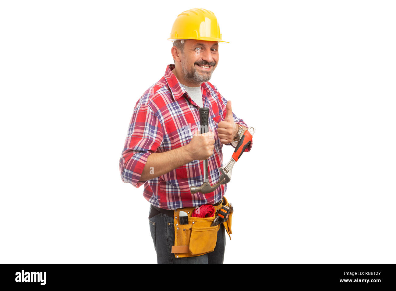 Friendly constructor showing thumb-up as like gesture and holding hammer and wrench isolated on white background Stock Photo