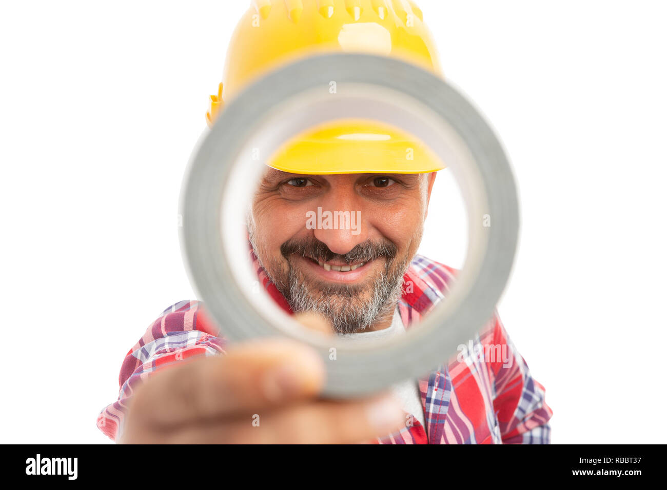 Smiling constructor looking through duct tape isolated on white studio background Stock Photo