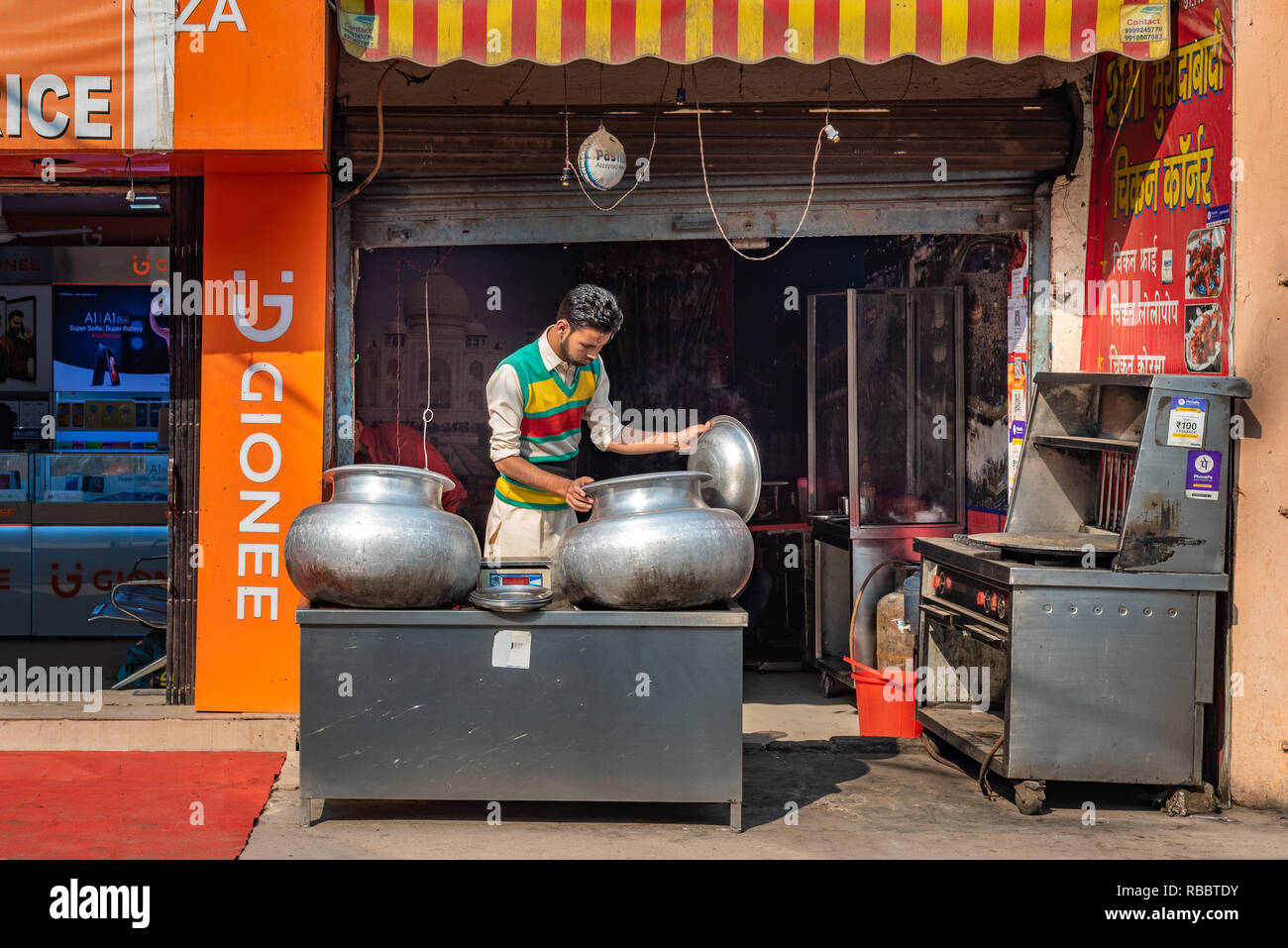 Dhabha or Indian restaurant owner inspects his signature dish in 'Chicken Corner Restaurant' in Madanpur Khadar, New Delhi. Stock Photo
