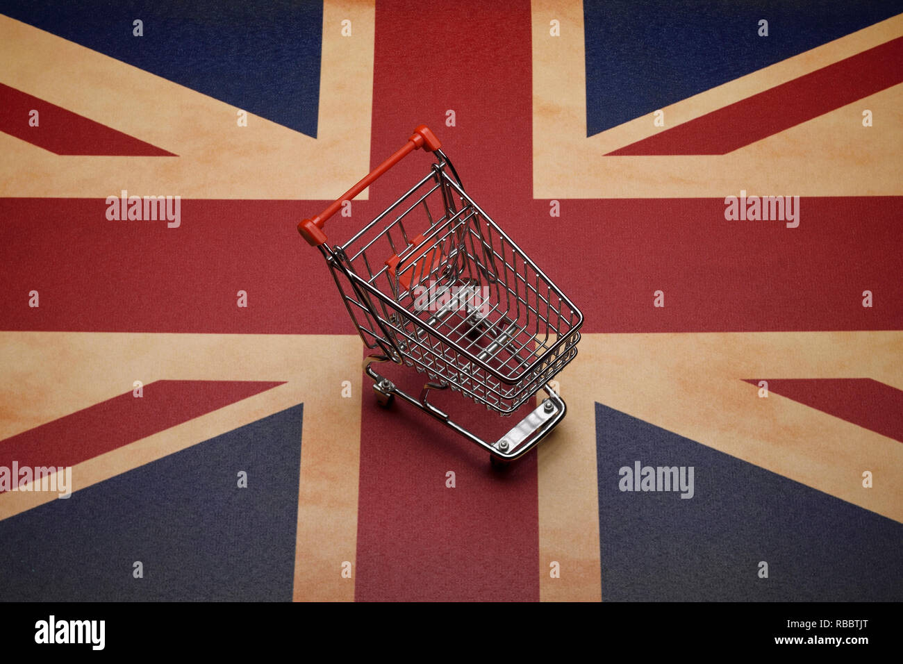 A mini shopping trolley sitting on a Union Jack flag Stock Photo Alamy