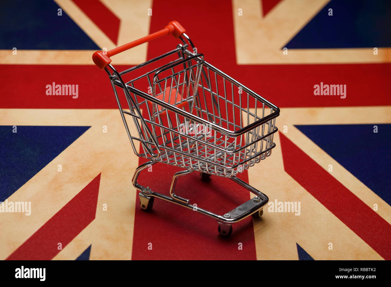 A mini shopping trolley sitting on a Union Jack flag Stock Photo Alamy