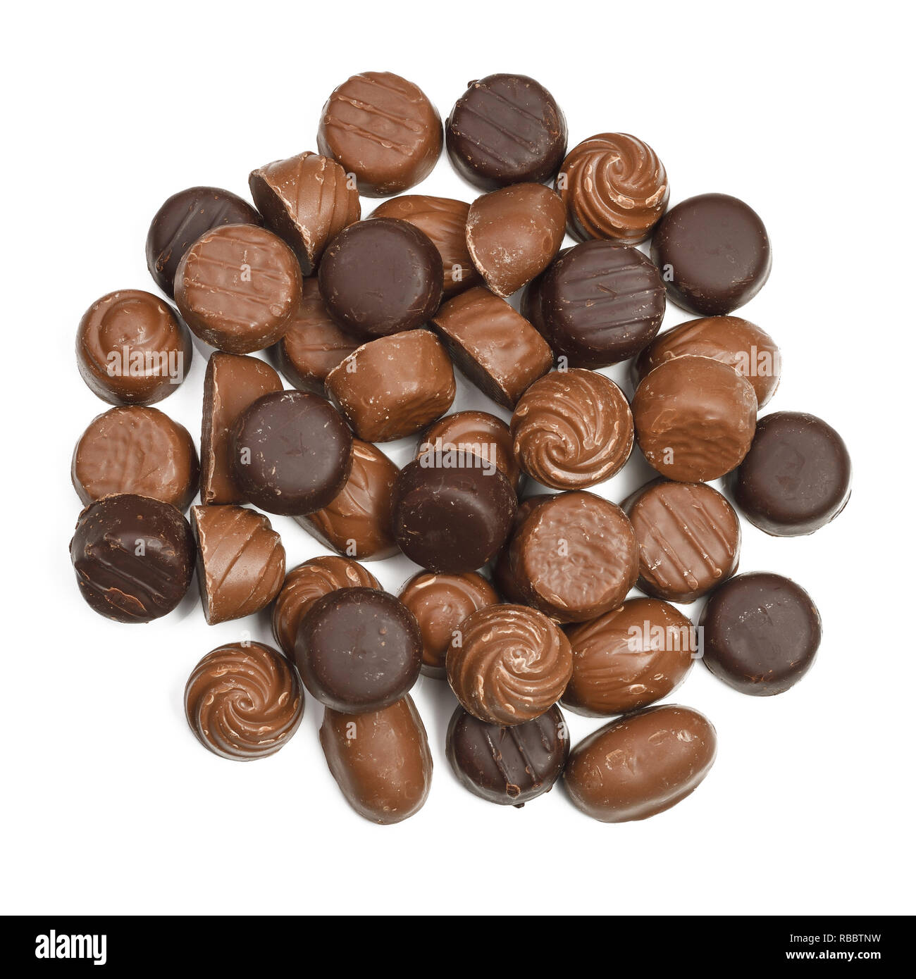 Looking down on a pile of unwrapped chocolate sweets Stock Photo