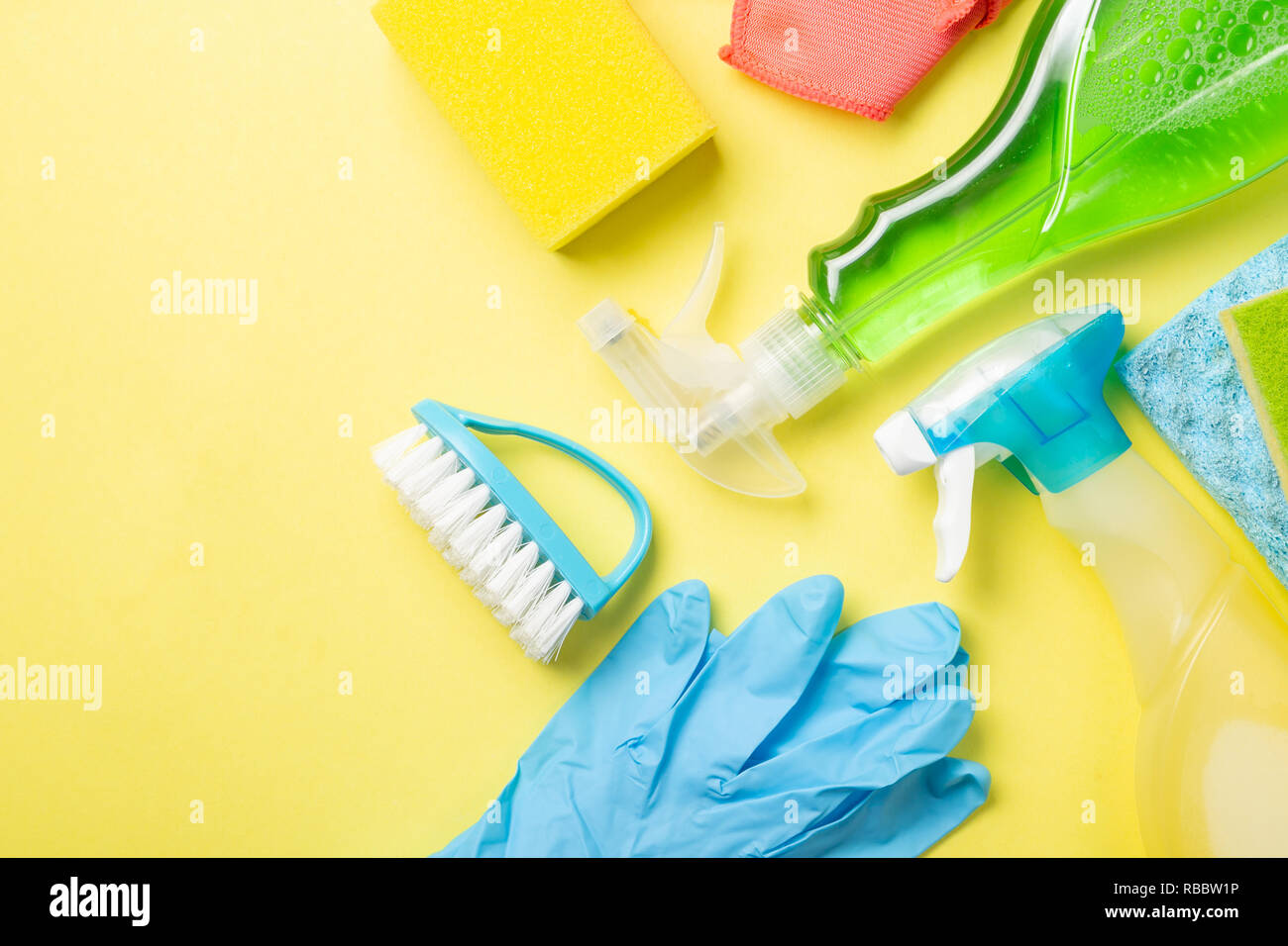 Cleaning concept cleaning supplies on pastel yellow background Stock