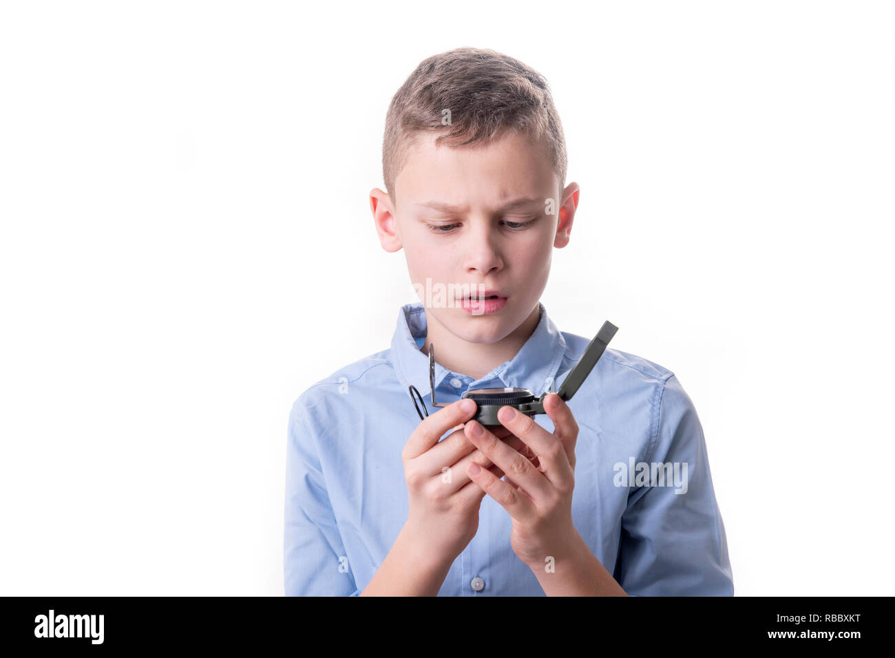 Boy brooding over his future sitting with a compass in his hand and ...