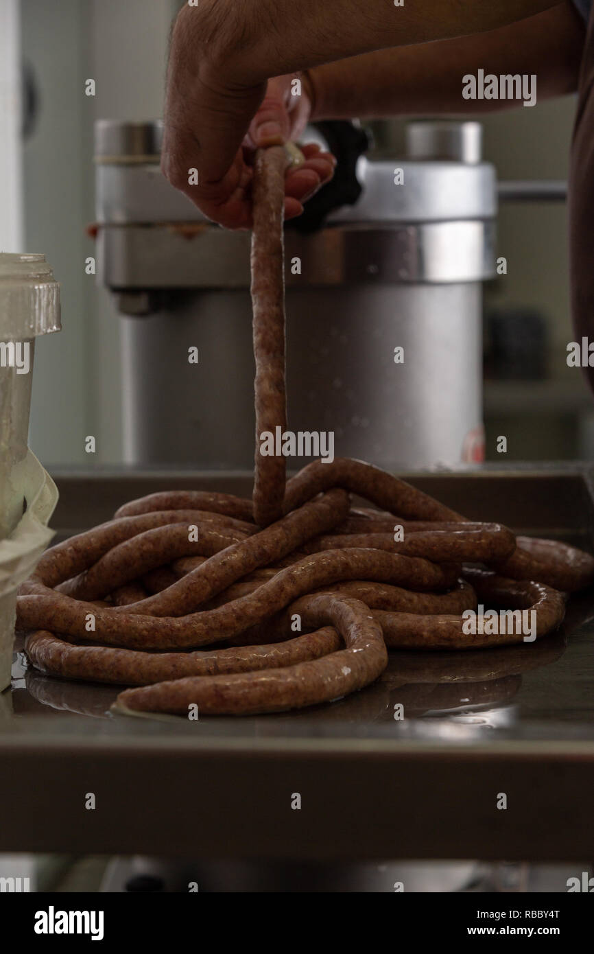 Butchers sausage machine making pork hires stock photography and