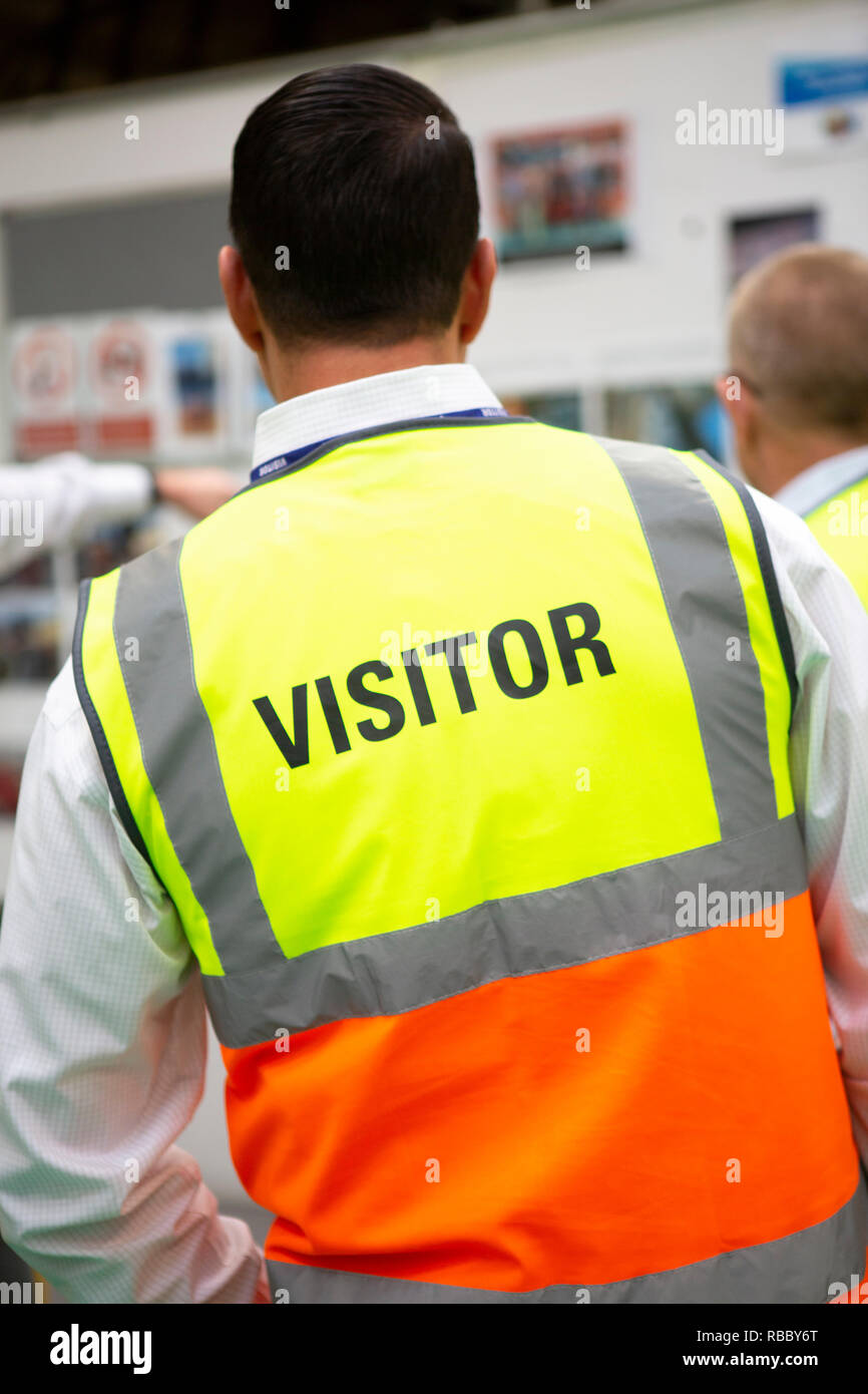 Visitors wearing PPE in a manufactoring plant Stock Photo