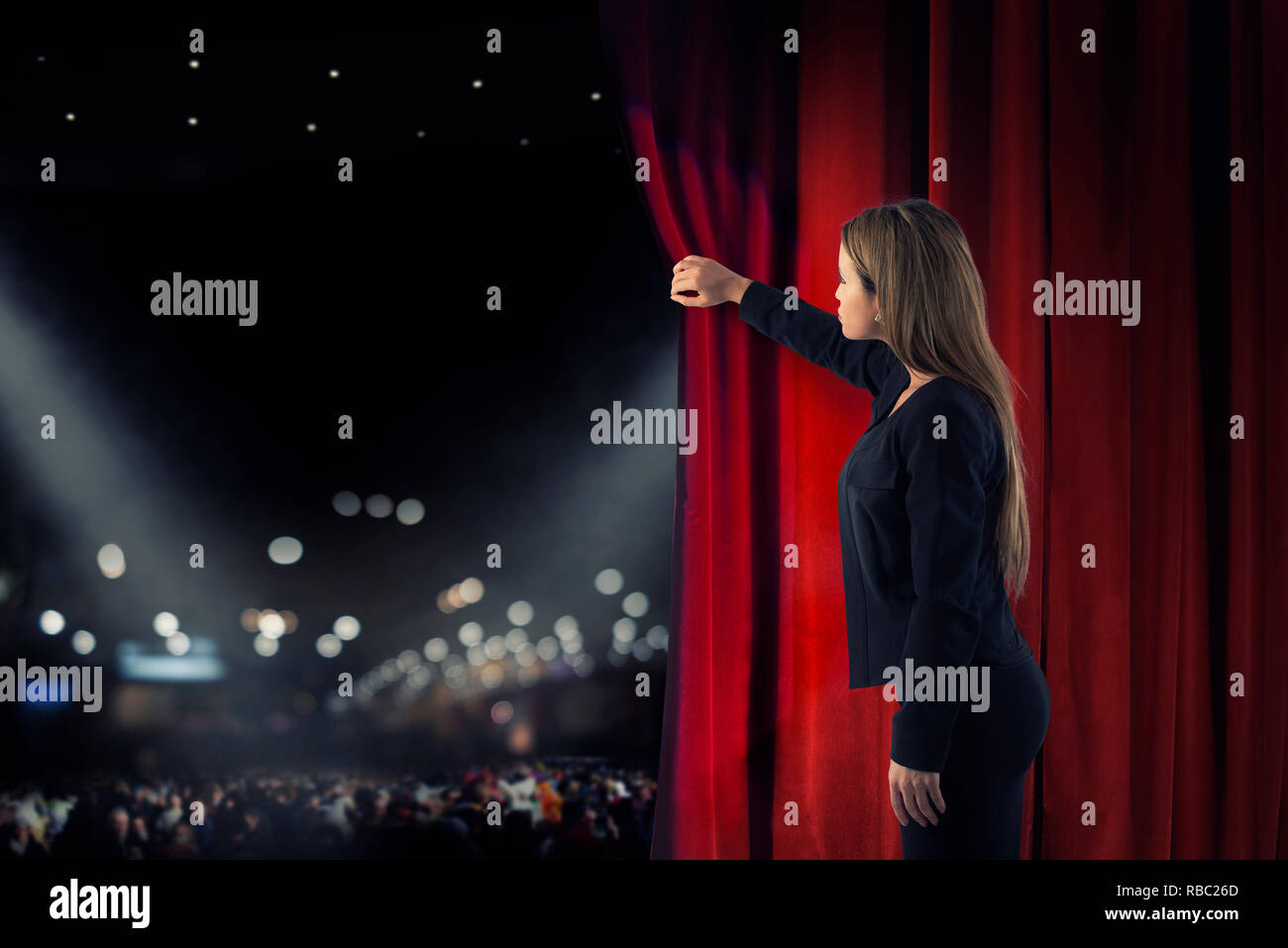 Woman open red curtains of the theater stage Stock Photo
