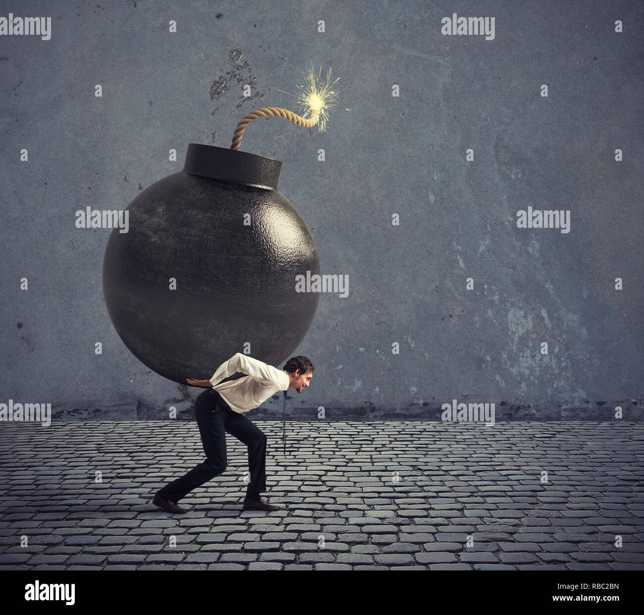 Businessman hold a bomb. Concept of difficult career and failure Stock Photo